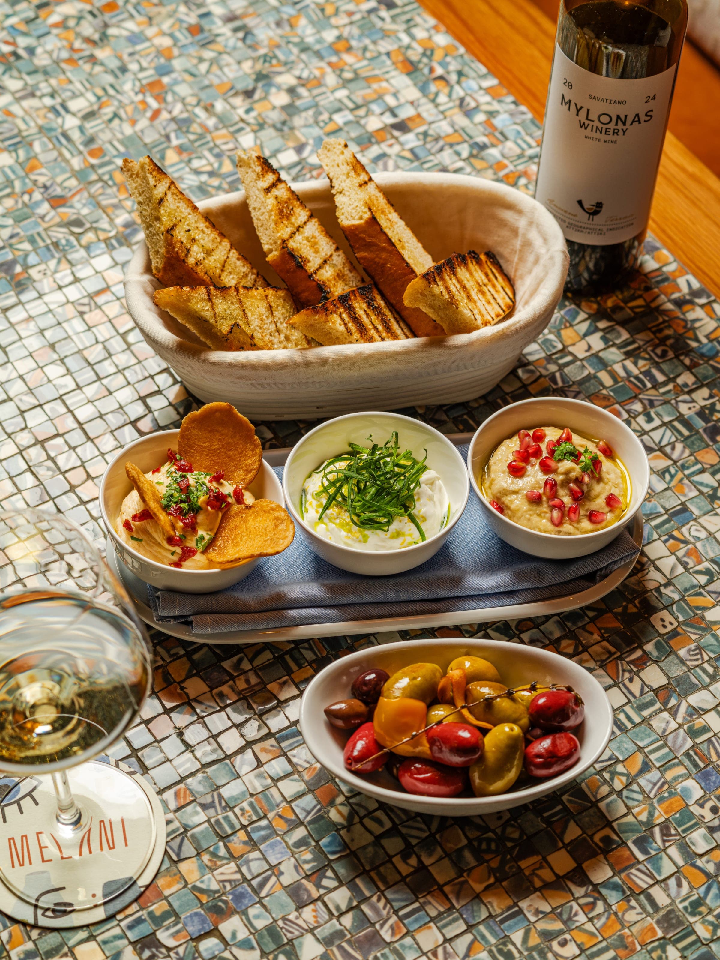 Greek mezze spread with dips, olives, and bread